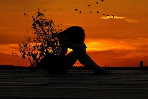 despair Silhouette of broken woman in sunset