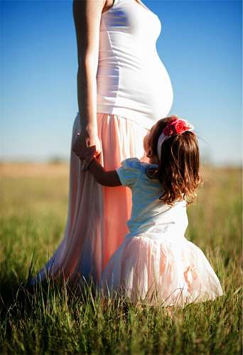 Pregnant mother with her daughter outdoors