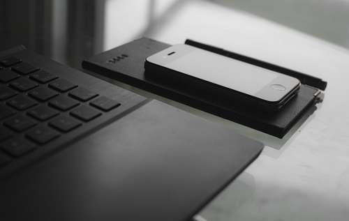 Desk with notebook, note and smartphone