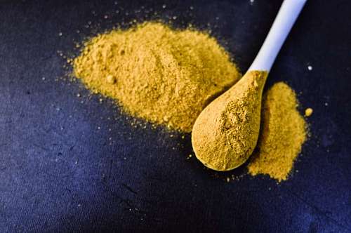 eastern heap of curcuma powder isolated on Black background