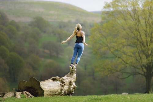 feelings Woman balancing on a trunk