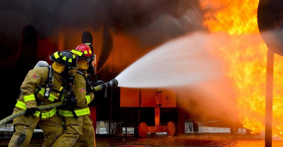 Firefighter, Rescue, Inferno, Hose, Motion, Safety, Protection, Rescue Worker, Holding, Helmet, Night, Color Image, Dynamite, Headwear, Heat - Temperature, Horizontal, Illuminated, Outdoors, People, Protective Workwear, Sand, Standing, Unrecognizable Person, Watering, Weapon, Work Helmet