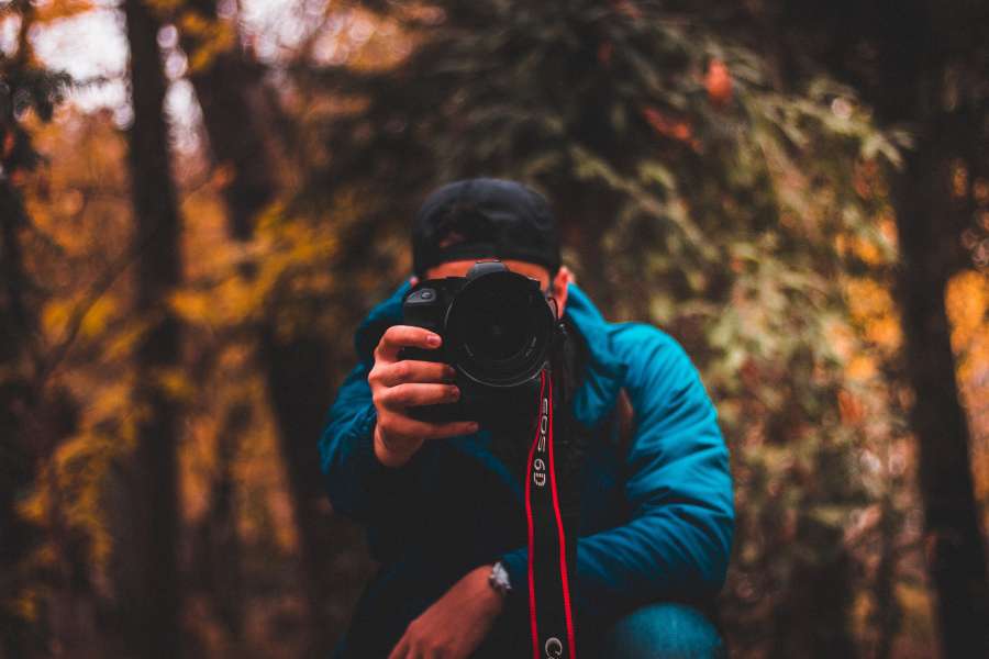 photographer, camera, background, man, photography, white, male, photograph, portrait, photo, hand, technology, person, isolated, young, lens, people, adult, tourist, hobby, caucasian, face, fashion, closeup, professional, black, equipment, fun, focus, men, pointing, look, creativity, lifestyle, looking, cool, taking, guy, attractive, style, photographing, model, shot, casual, blue, one,  
