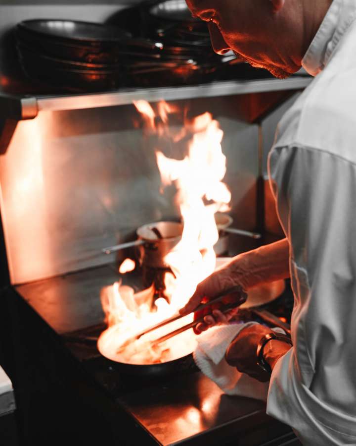 restaurant, cook, chef, food, kitchen, professional, cooking, work, cuisine, people, hotel, commercial, uniform, male, person, man, occupation, gourmet, preparation, job, culinary, catering, meal, men, lunch, indoors, dish, staff, making, business, industry, service, prepare, adult, dinner, pan, smile, protective, sauce, profession, young, white, salad, working, teamwork, table, fire, flambe, 