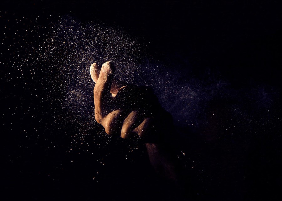 
black background, hand, dust, dark, concept, fine dirt,
