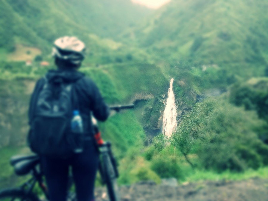 one person, people, woman, Ecuador, holy water baths, baths, waterfall bride foreground mountain landscape, sport, adventure, outdoor, day, woman, bicycle, sport, 