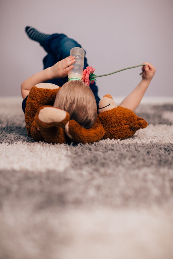 one person, people, child, carpet, living, drink, drinking, bottle, feeding bottle
