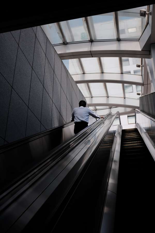escalator, business, man, modern, businessman, people, ascending, urban, indoors, view, standing, caucasian, motion, travel, adult, suit, photography, stairway, transportation, corporate, one, staircase, office, interior, technology, horizontal, only, high, men, convenience, angle, side, move, journey, stairs, structure, commercial, quarter, background, city, building, architecture, glass, indoor, elevator, space, mid, briefcase, inside, blur, traveling, riding, three, length, up, waist, russia, mid adult, airport, well-dressed, broker, public, long, person, passage, trader, contemporary, moscow, job, only men, expertise, professional, delegate, employee, downwards, financier, young, executive, moving, economist, manager, station, profession, color image, elegant, lawyer, politician, differential focus, absence, transparent, empty, work space, walk, copy space, pedestrian, null, company, answering, three quarter length, cell phone, talking, workplace, concentrating, lift, metro, lamp, transport, listening, phoning, perspective, high angle view, communication, steps, bald, underground, agent, subway, exit, working, construction, tokyo international forum, wristwatch, rushing, impatient, and, futuristic, late, front, women, hall, retail, concept, buy, shop, crowd, holding, vertical, copy, mature, leaving, on, profile, the, happy, camera, looking, checking, at, railing, smiling, confidence, speed, design, tokyo, side view, full suit, on the move, mid section, japan, outdoors, urban scene, day, office building, city location, business person, business man, downtown district, two people, fashion, zoom, abstract, centre, mall, floor, center, store, arriving, movement, customer, luxury, light, market, sale, leader