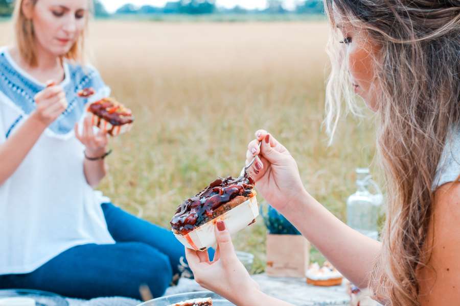 picnic, food, eating, outside, two people, people, woman, young, friends, activity, outing, outdoors, pancake, jam,

