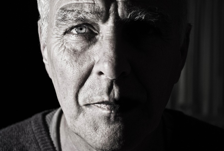 one person, people, man, adult, black and white, looking at camera, close-up, face, detail, shadow, 50 years old, serious,