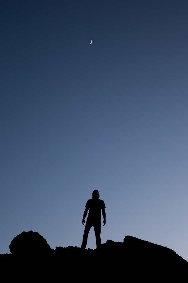 one person, people, man, mountain, moon, night, night, looking up, concept, freedom, space, shadow, silhouette,