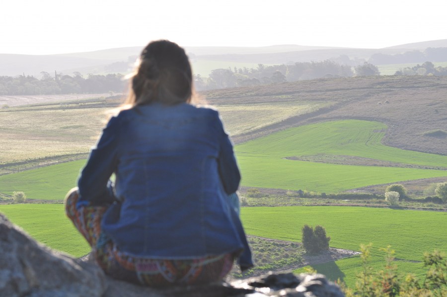 one person, woman, landscape, mountain, horizont, relax, freedom, adult, staring, looking, tranquility, quiet,sitting, rock, field, rural, 