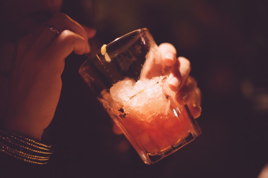 one person, taking, drink, drinking, driend, ice, cold, interior, bar, night, nightime, glass, cocktail, people, 