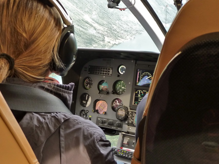 two people, man, woman, helicopter, flying, transportation, intrumental, panel, instruments, navigation, browse, watch, blond, blonde,