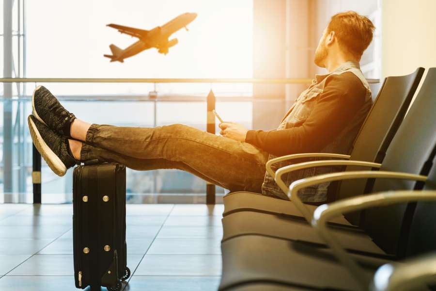 airport, travel, traveler, flight, man, passenger, businessman, waiting, trip, business, male, terminal, luggage, people, person, lounge, caucasian, transport, vacation, station, plane, one, tourist, baggage, departure, journey, sitting, airplane, suitcase, adult, phone, young, international, transportation, mobile, delay, suit, technology, handsome, window, flying, communication, bag, tired, modern, building, standing, tourism, men, wait